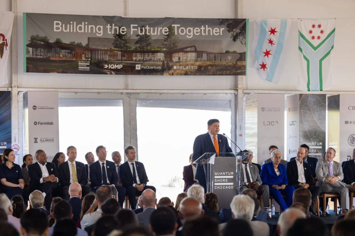 Governor Pritzker speaks on stage at the IQMP groundbreaking ceremony.