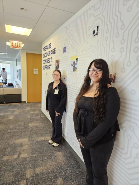 Two sisters, Alizah and Nerida Coronado, pose at the IQMP office where they are interning for the summer.